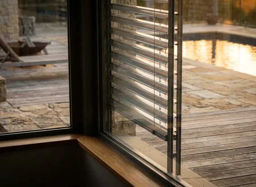 External venetian blind with aluminium slats hanging outside the glass on a Kyalami patio elevation